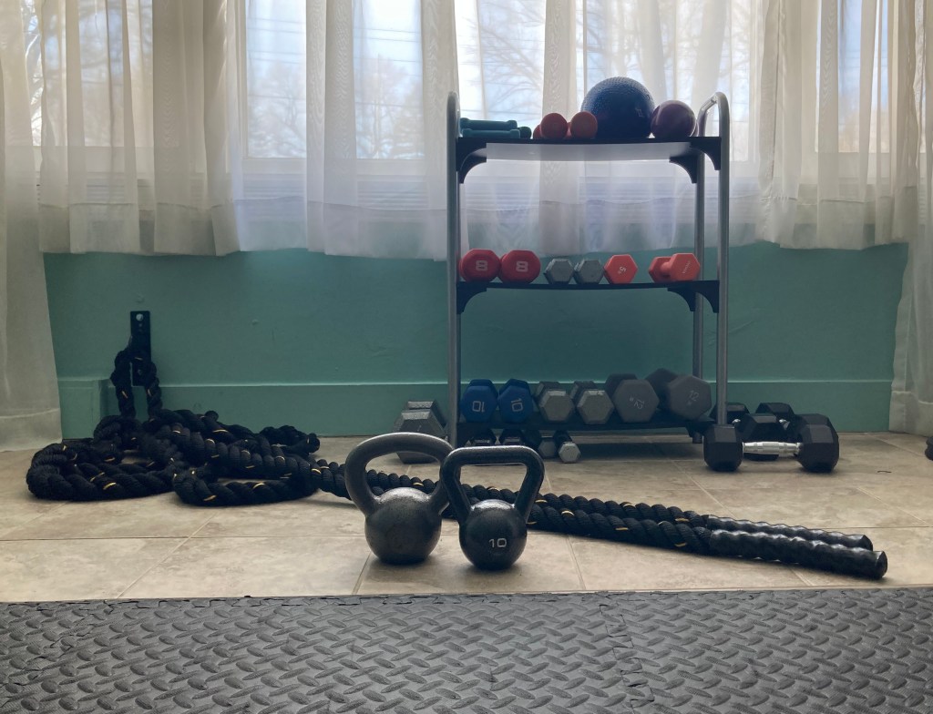 Battle ropes, kettlebells, and rack of dumbbells.